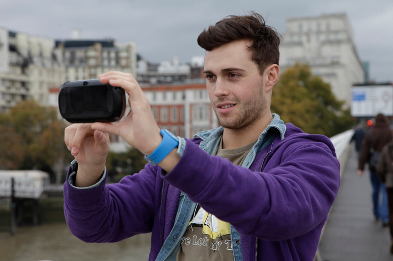 Illustration for article titled Attractive Young Men Smiling at the PlayStation Vita